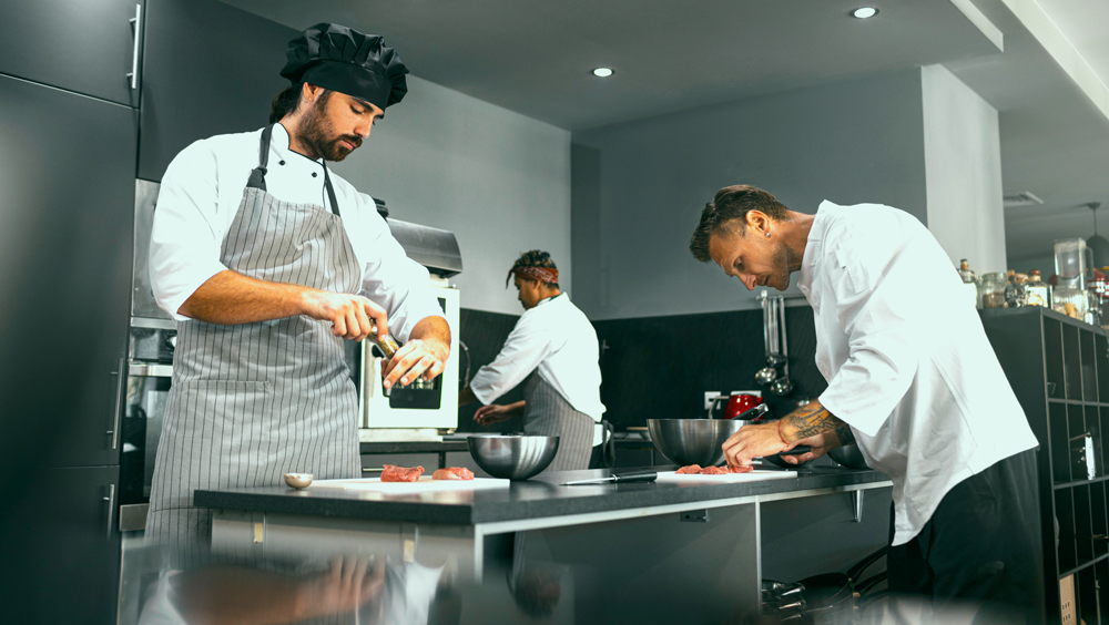 chef cuisinier travaillant ensemble cuisine professionnelle